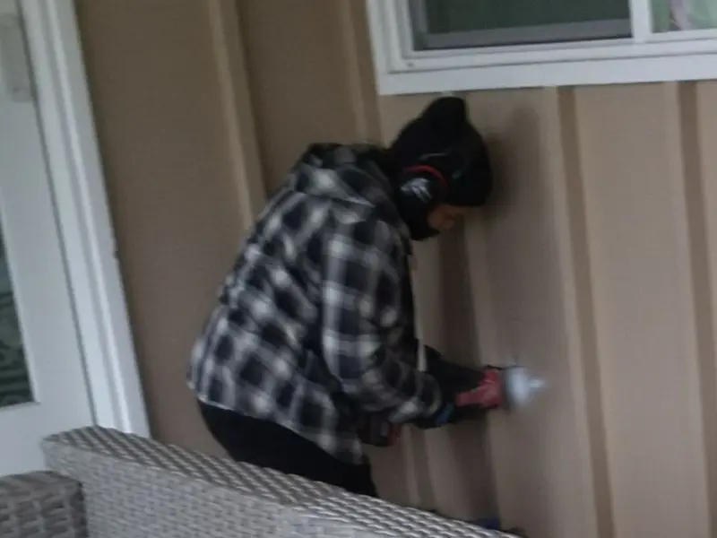 Professional electrician installing an exterior outlet in Hendron