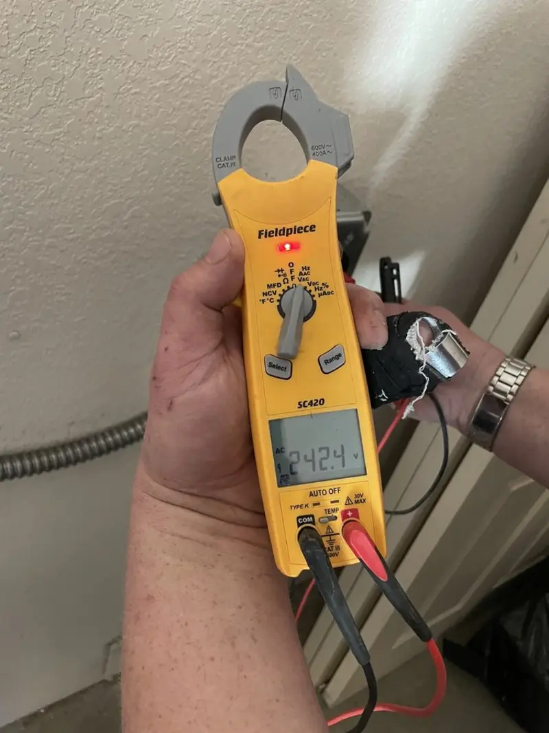 Voltage testing with clamp meter during Ceiling Fan Installation in Hendron